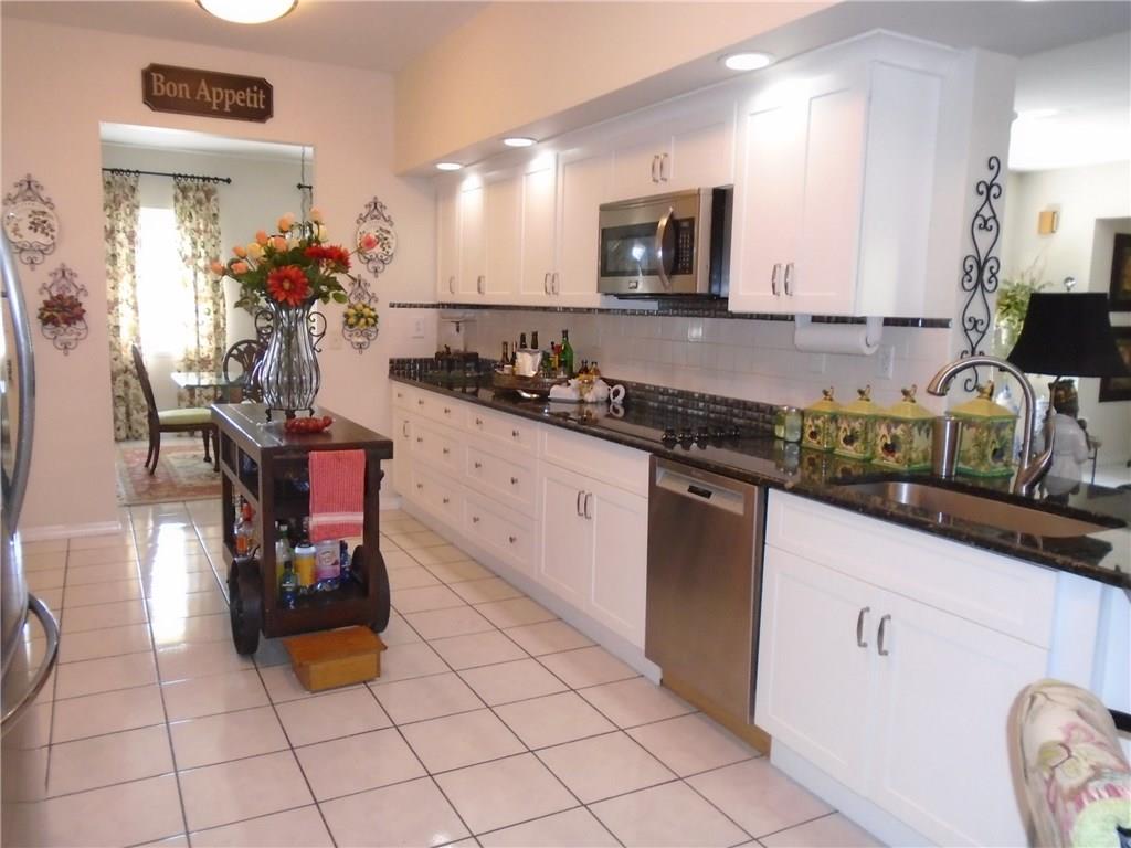 2185 Southeast Harding Street Port St. Lucie, FL 34952 - Photo 11 of 34 a kitchen with a sink and cabinets