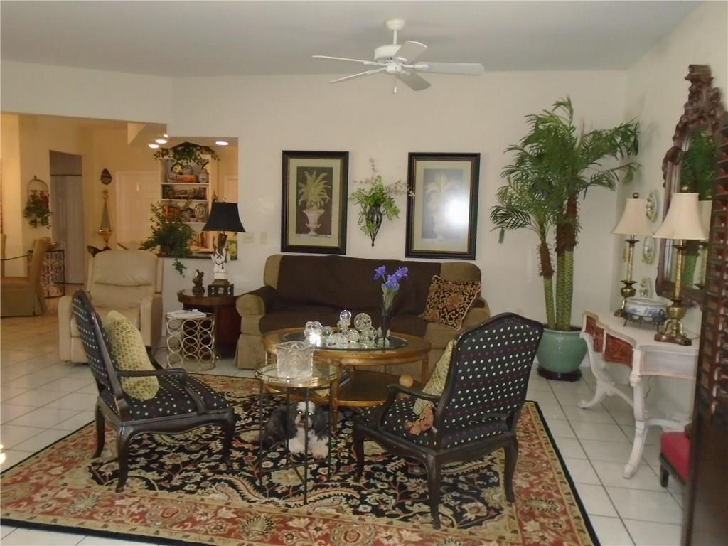 2185 Southeast Harding Street Port St. Lucie, FL 34952 - Photo 14 of 34 a view of a dining room with furniture and wooden floor