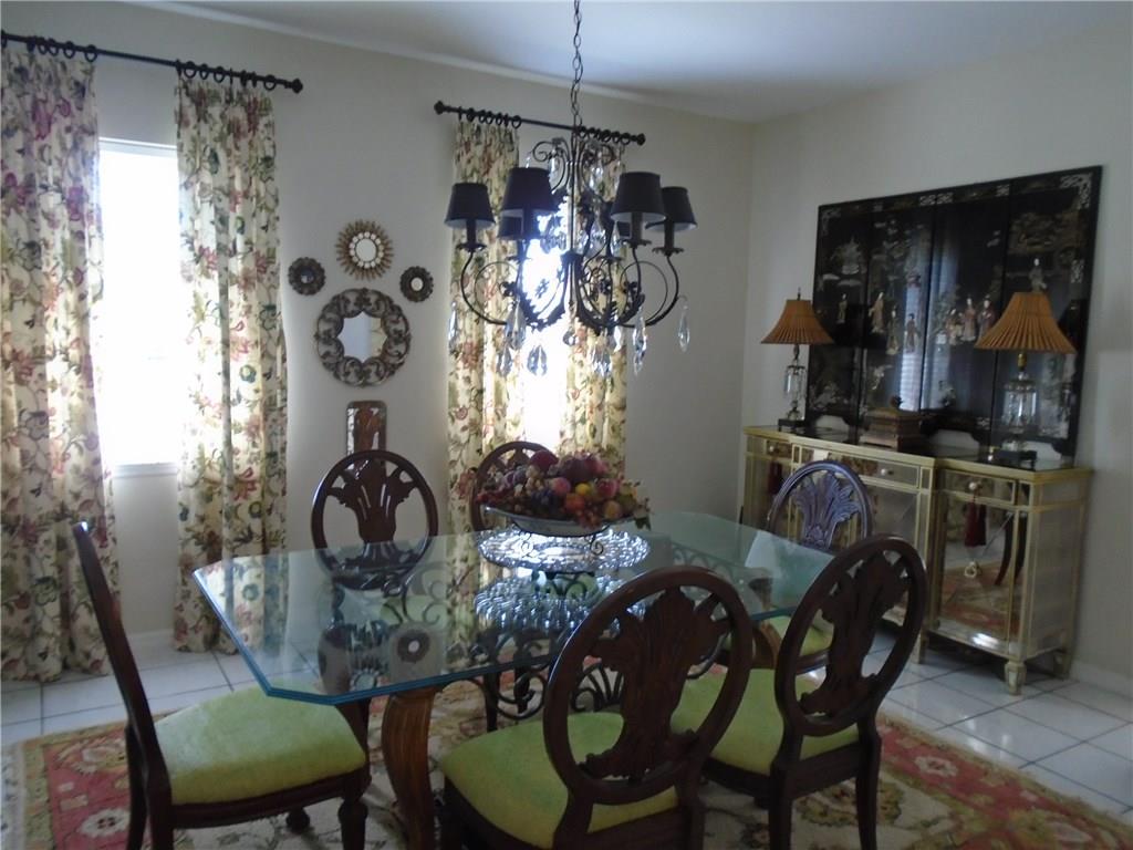 2185 Southeast Harding Street Port St. Lucie, FL 34952 - Photo 16 of 34 a view of a dining room with furniture and chandelier