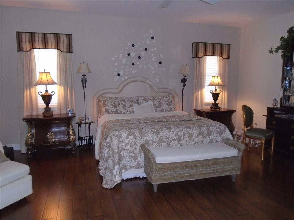 2185 Southeast Harding Street Port St. Lucie, FL 34952 - Photo 18 of 34 a bed sitting in a spacious bedroom next to a window