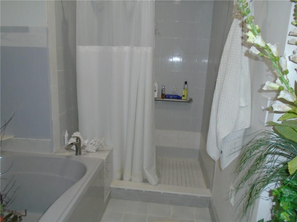 2185 Southeast Harding Street Port St. Lucie, FL 34952 - Photo 19 of 34 a bathroom with a bathtub and shower