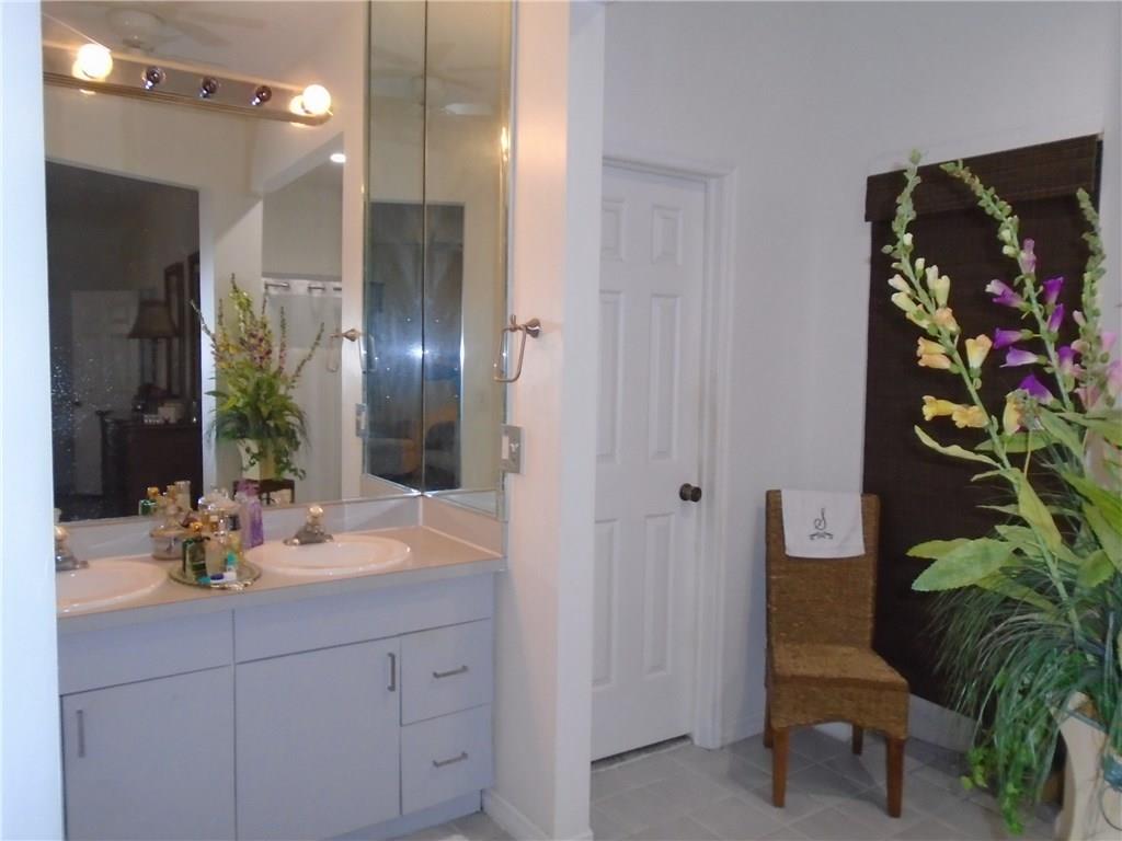 2185 Southeast Harding Street Port St. Lucie, FL 34952 - Photo 20 of 34 a bathroom with a sink and a mirror