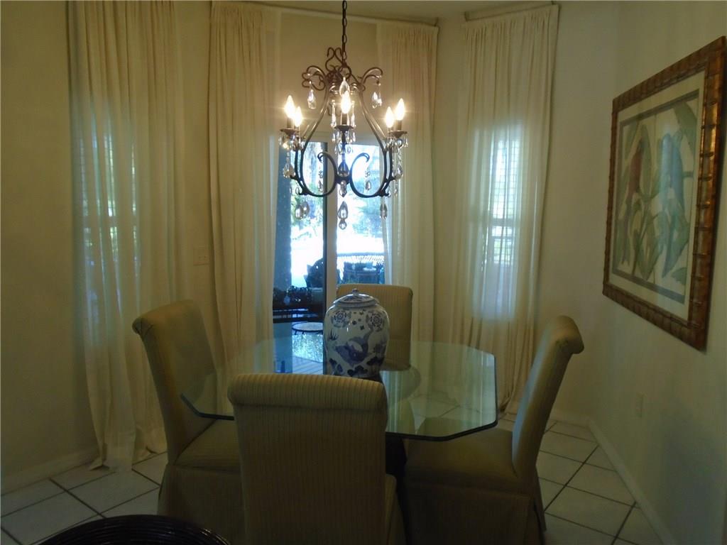 2185 Southeast Harding Street Port St. Lucie, FL 34952 - Photo 22 of 34 a living room with furniture and a chandelier