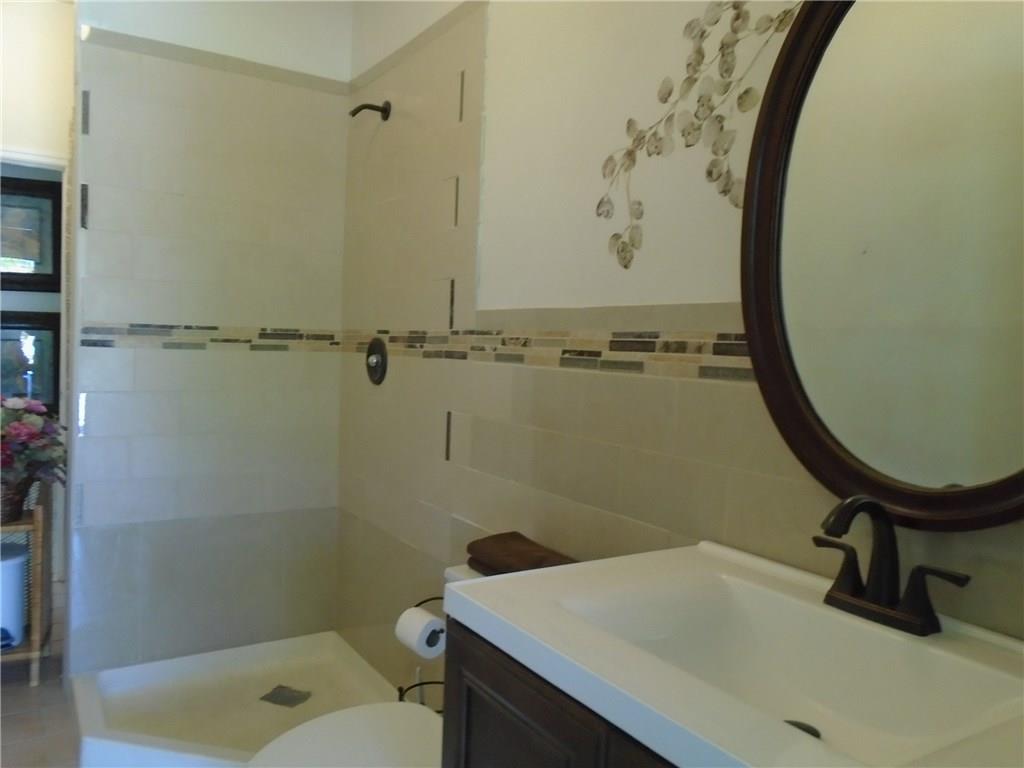 2185 Southeast Harding Street Port St. Lucie, FL 34952 - Photo 23 of 34 a bathroom with a sink a toilet and shower
