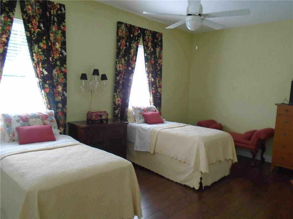 2185 Southeast Harding Street Port St. Lucie, FL 34952 - Photo 24 of 34 a bedroom with a bed and a chandelier