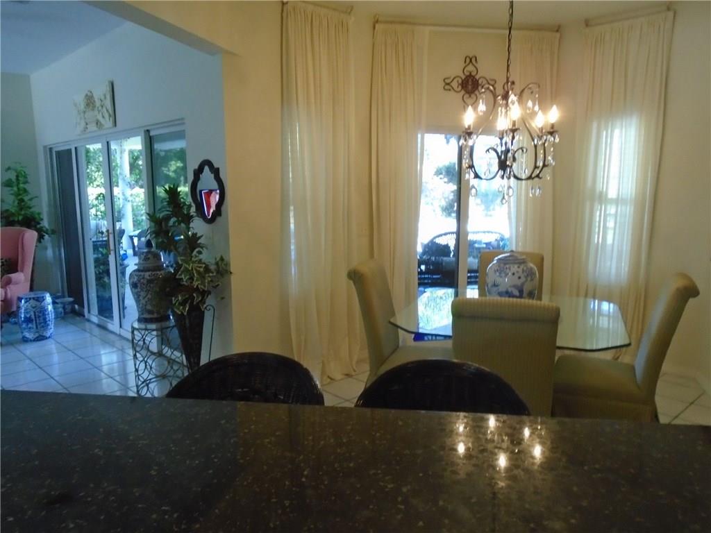 2185 Southeast Harding Street Port St. Lucie, FL 34952 - Photo 28 of 34 a living room with furniture and a chandelier