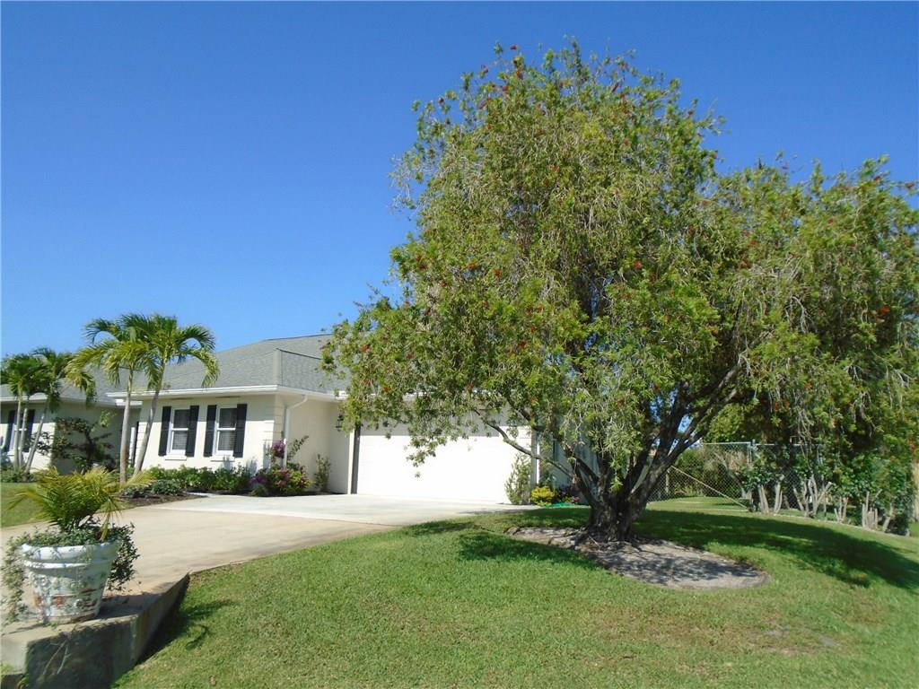 2185 Southeast Harding Street Port St. Lucie, FL 34952 - Photo 30 of 34 a front view of a house with a garden