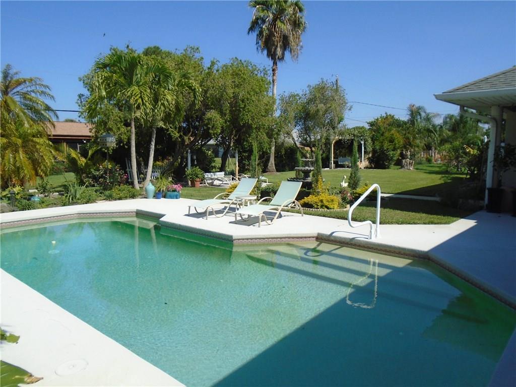 2185 Southeast Harding Street Port St. Lucie, FL 34952 - Photo 3 of 34 a view of a house with swimming pool and sitting area