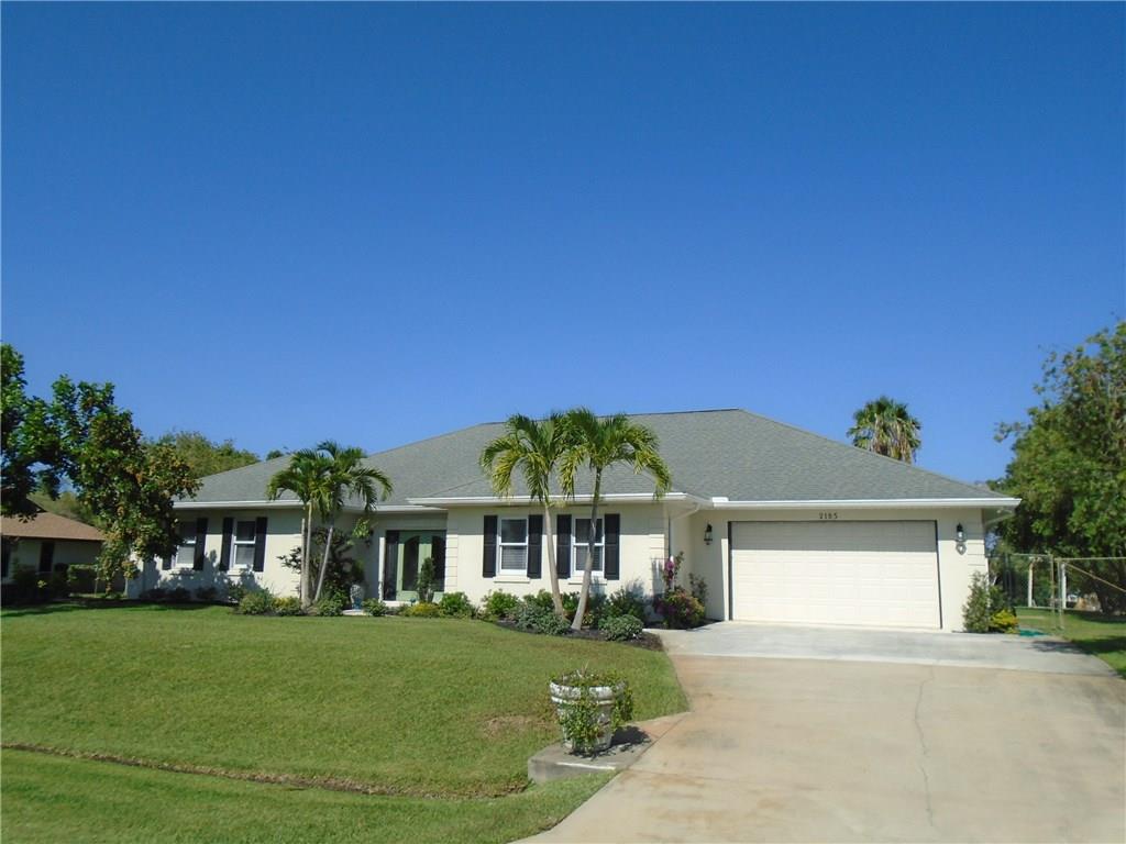 2185 Southeast Harding Street Port St. Lucie, FL 34952 - Photo 31 of 34 a front view of a house with a garden