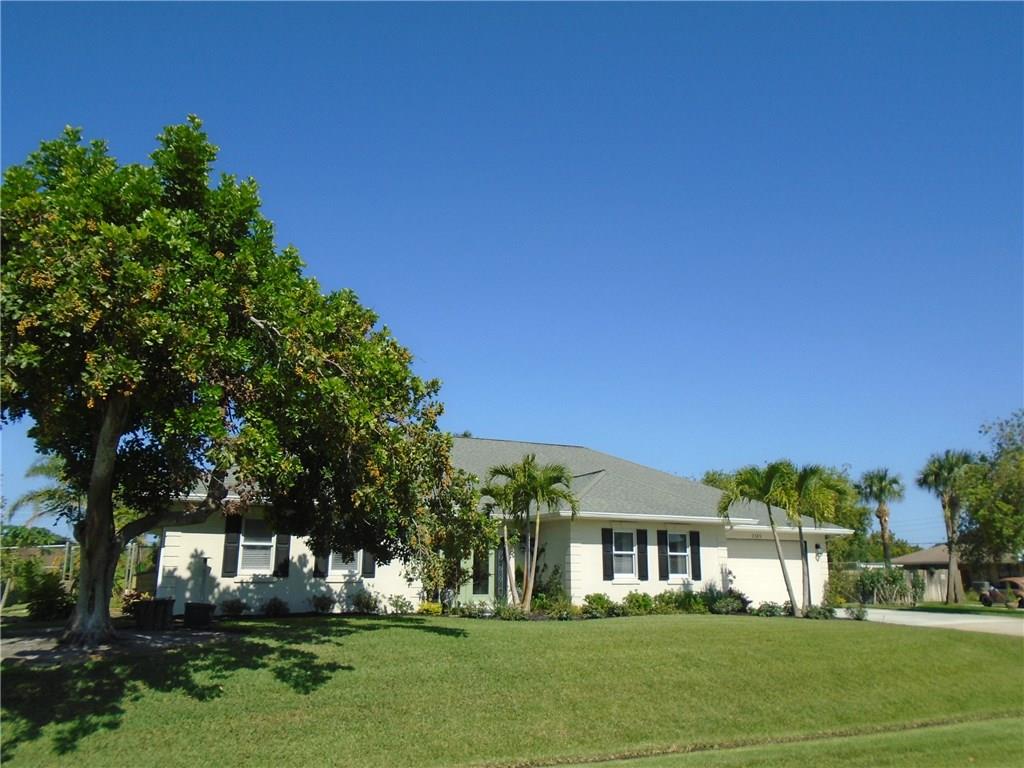 2185 Southeast Harding Street Port St. Lucie, FL 34952 - Photo 32 of 34 a front view of a house with a yard
