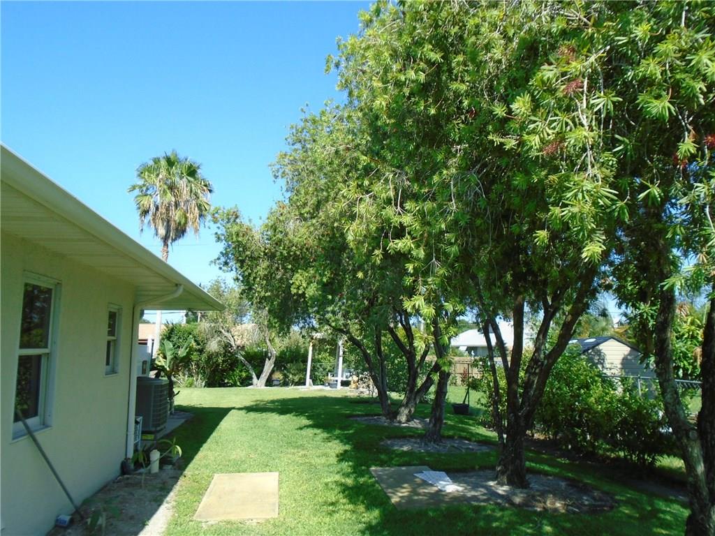 2185 Southeast Harding Street Port St. Lucie, FL 34952 - Photo 33 of 34 a backyard of a house with lots of green space