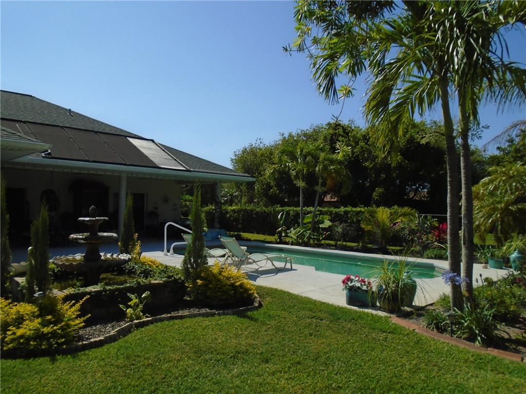 2185 Southeast Harding Street Port St. Lucie, FL 34952 - Photo 5 of 34 a front view of a house with garden