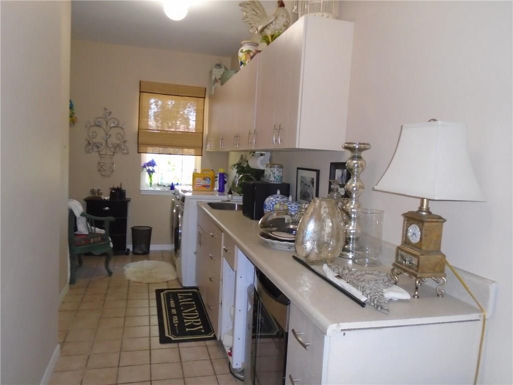 2185 Southeast Harding Street Port St. Lucie, FL 34952 - Photo 10 of 34 a kitchen with sink a stove and cabinets