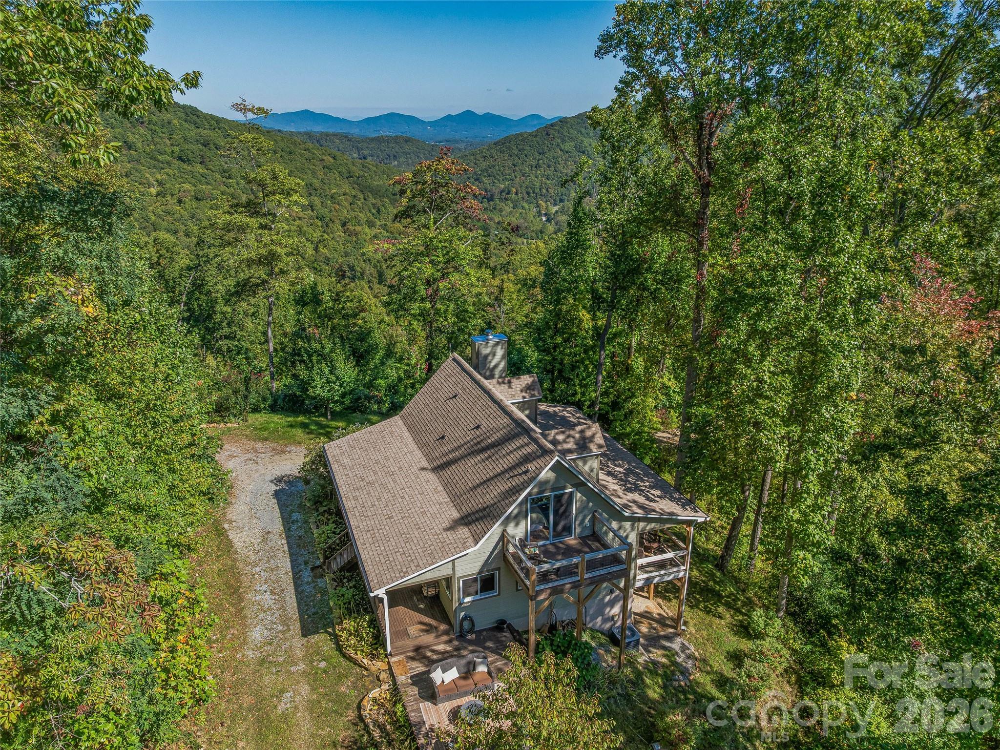 382 Black Oak Cove Road Candler, NC 28715 - Photo 1 of 46 a view of a backyard with sitting area