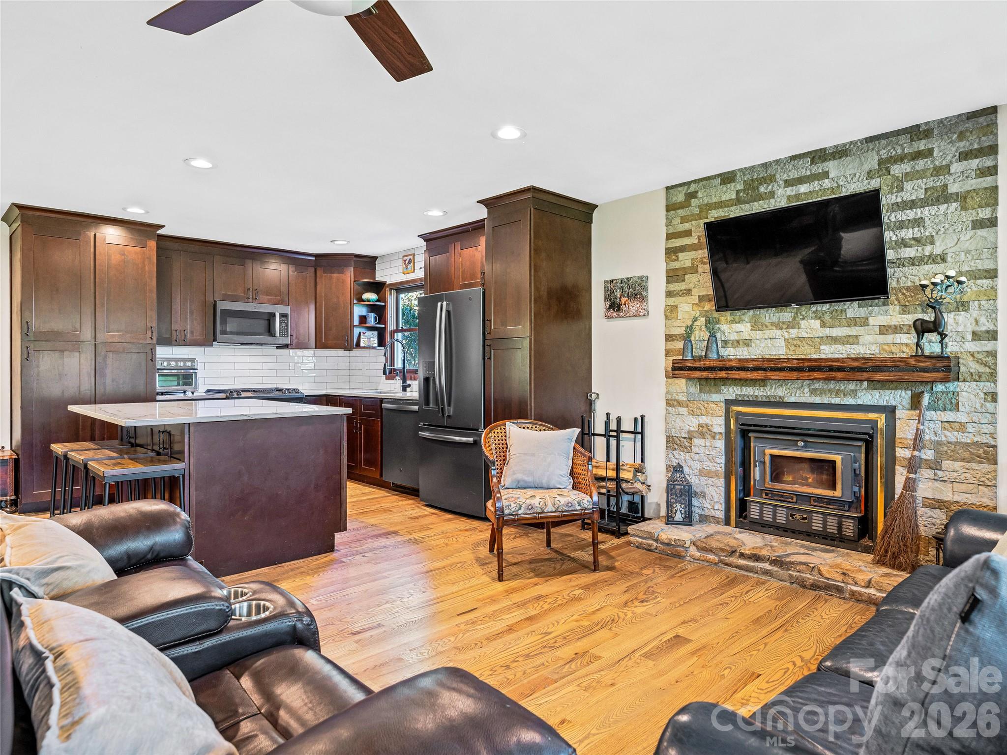 382 Black Oak Cove Road Candler, NC 28715 - Photo 11 of 46 a living room with furniture and a flat screen tv
