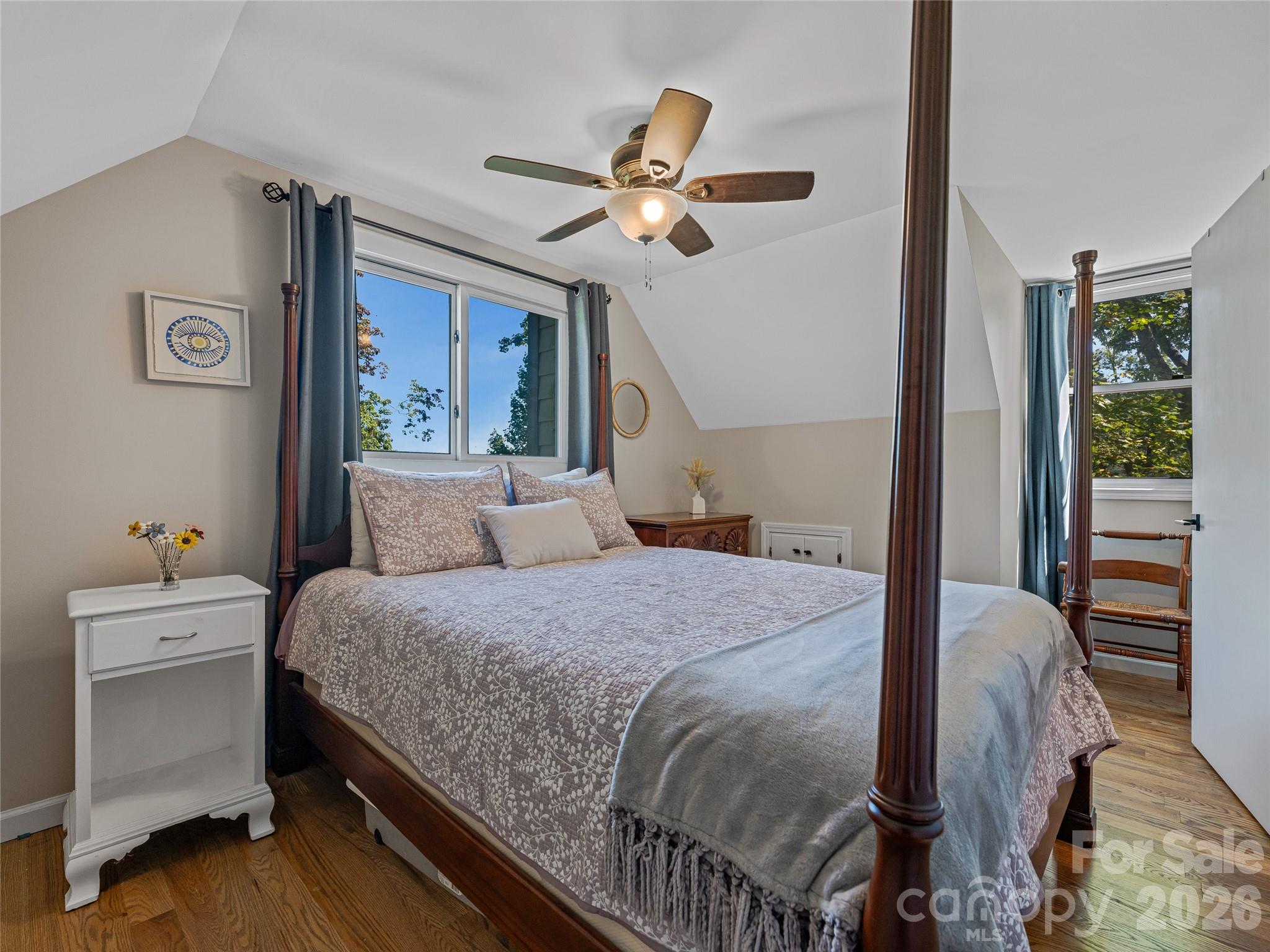 382 Black Oak Cove Road Candler, NC 28715 - Photo 31 of 46 a bedroom with a bed and a chandelier