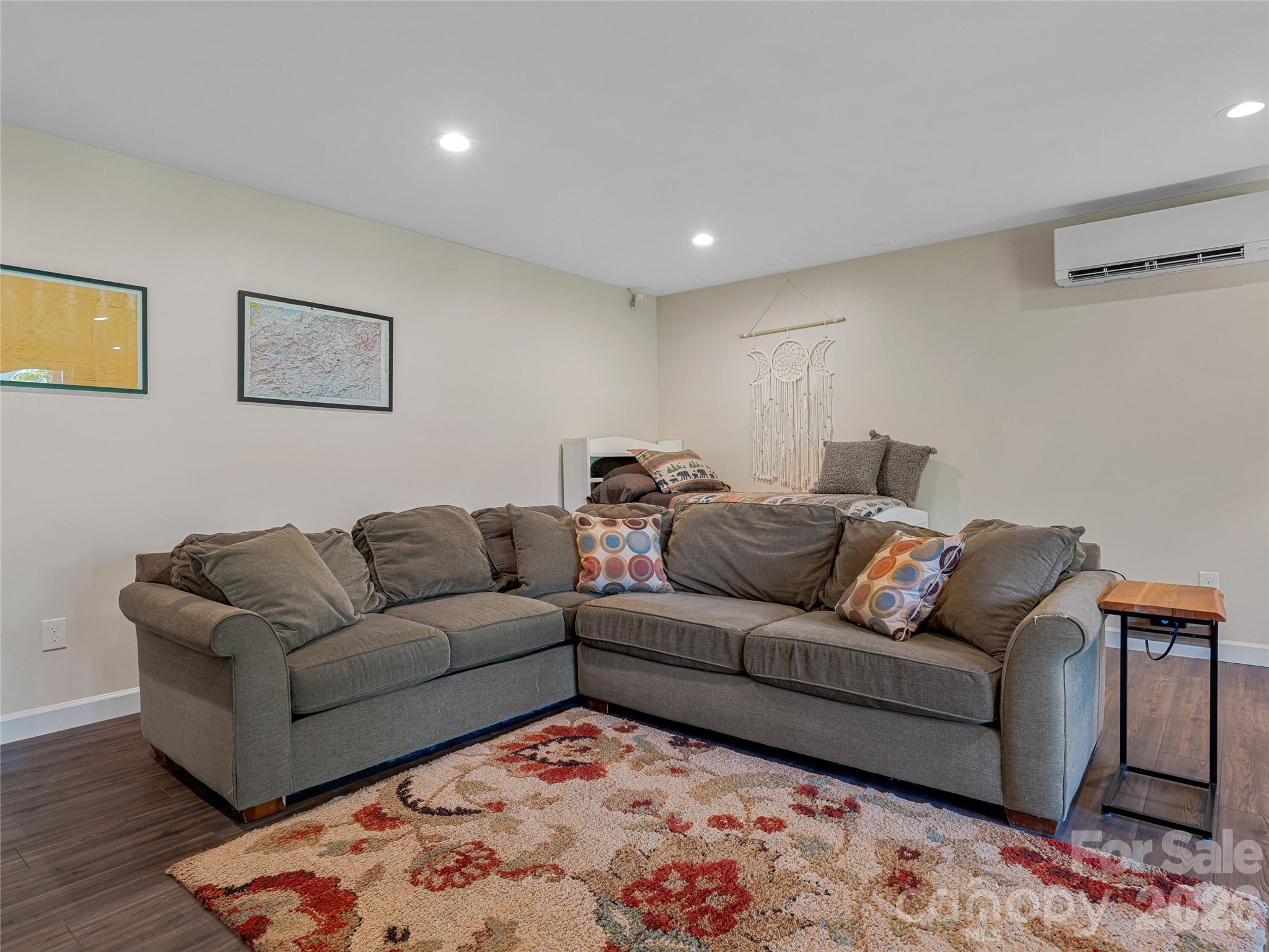 382 Black Oak Cove Road Candler, NC 28715 - Photo 32 of 46 a living room with furniture and painting on the wall