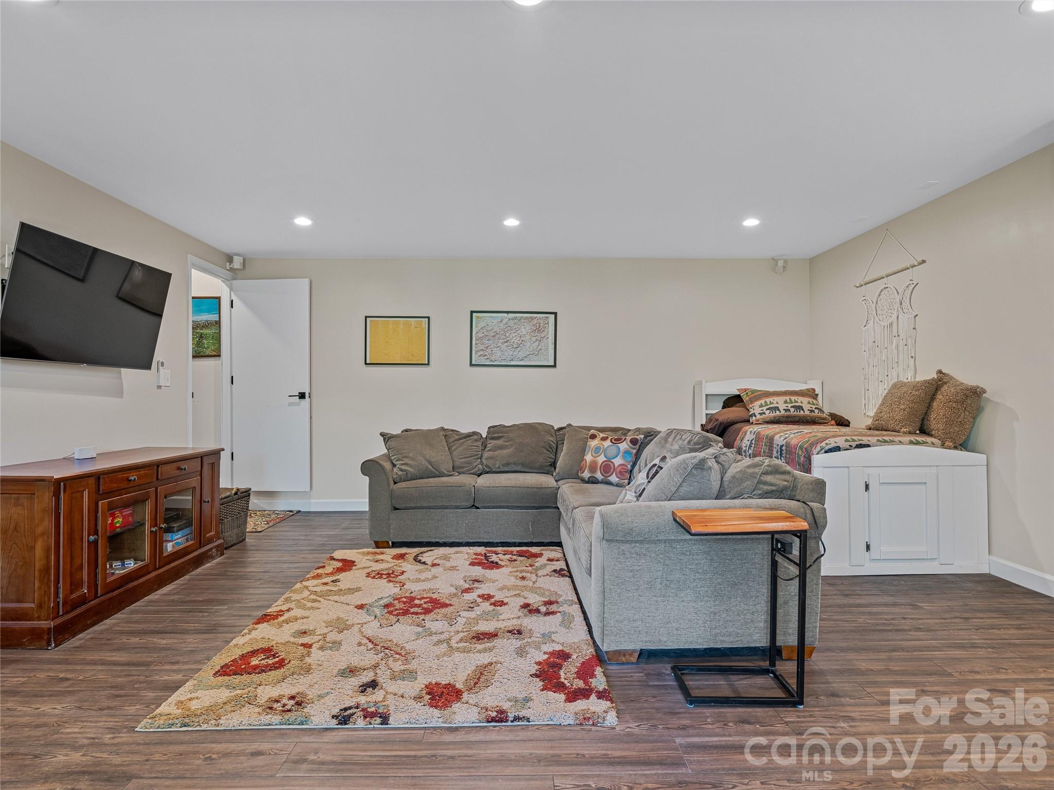 382 Black Oak Cove Road Candler, NC 28715 - Photo 34 of 46 a living room with furniture and a flat screen tv
