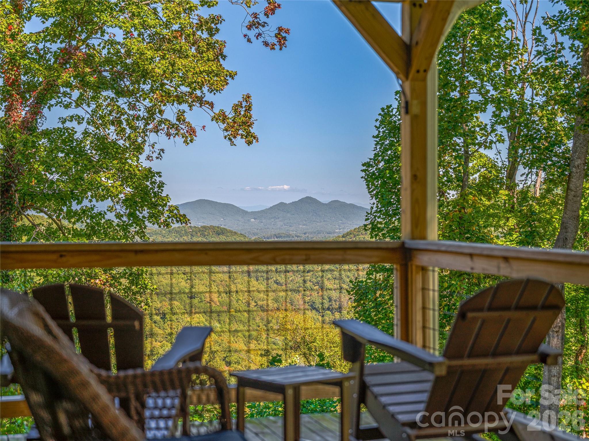 382 Black Oak Cove Road Candler, NC 28715 - Photo 4 of 46 a view of a balcony with chair and wooden floor