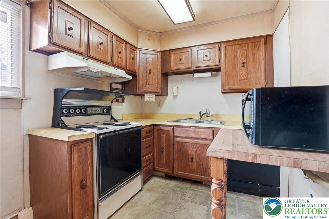 5478 2nd Street Whitehall, PA 18052 - Photo 14 of 30 a kitchen with a stove and a microwave
