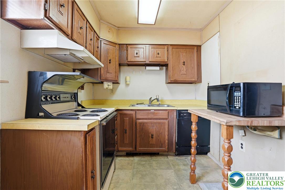 5478 2nd Street Whitehall, PA 18052 - Photo 15 of 30 a kitchen with stainless steel appliances granite countertop a stove and a sink
