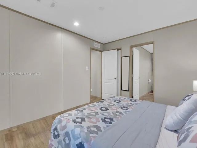 a bedroom with a bed and a dresser