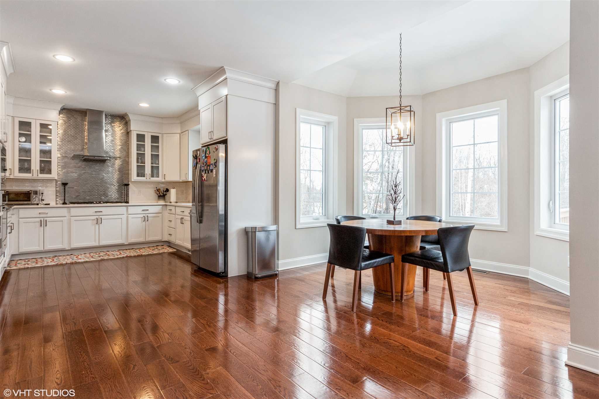 25 Riding Ridge Trail Beacon, NY 12508 - Photo 8 of 25 a kitchen with stainless steel appliances granite countertop a table chairs refrigerator and sink