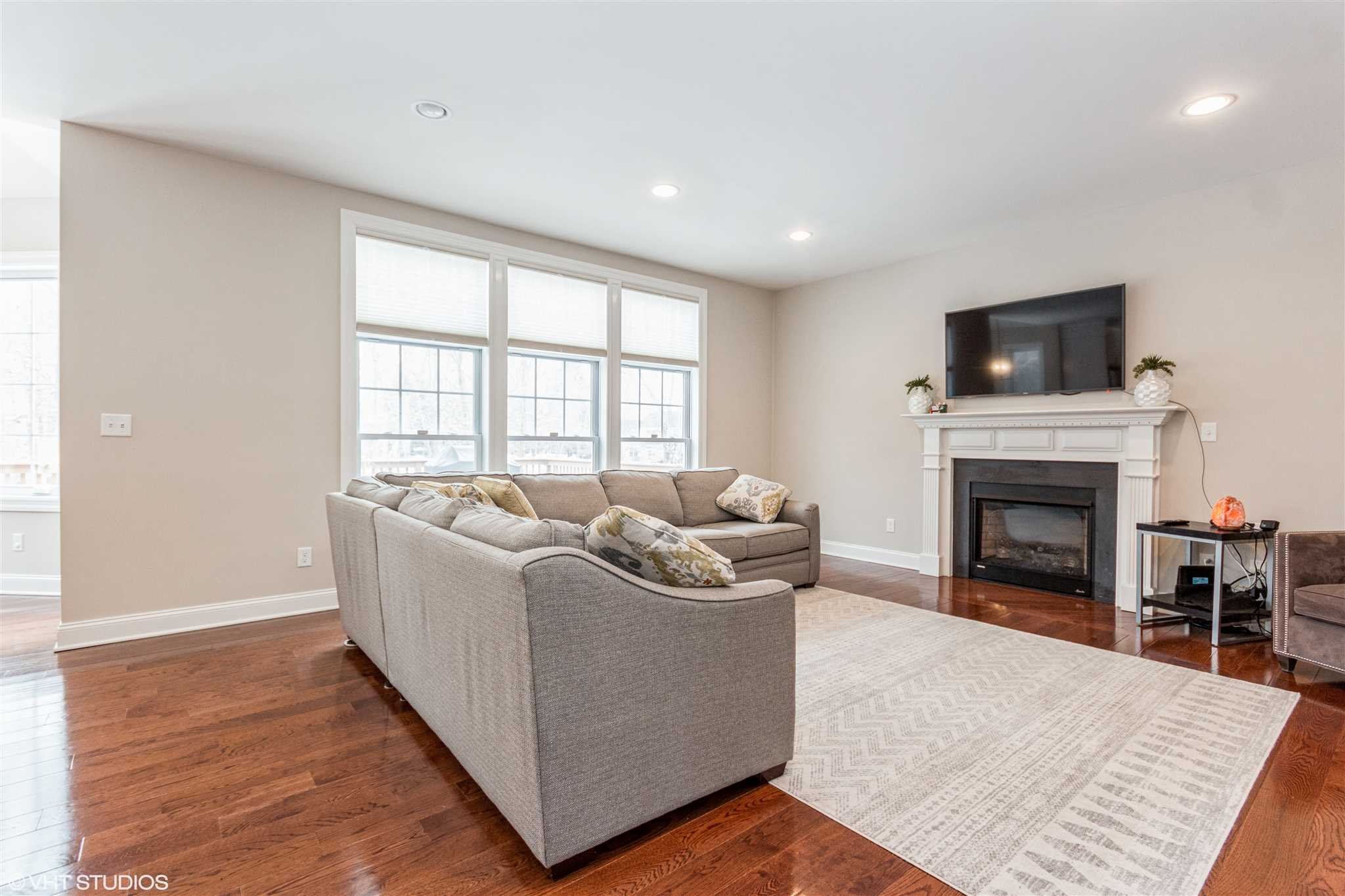 25 Riding Ridge Trail Beacon, NY 12508 - Photo 10 of 25 a living room with furniture a flat screen tv and a fireplace