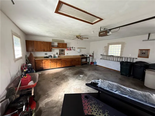 a living room with furniture and a dining table with kitchen view