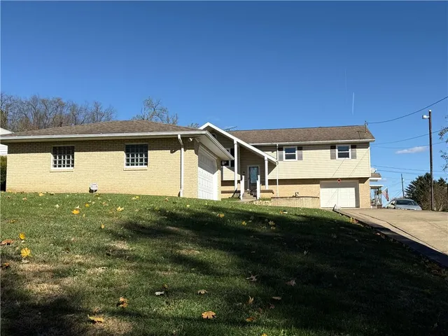 a front view of a house with a yard