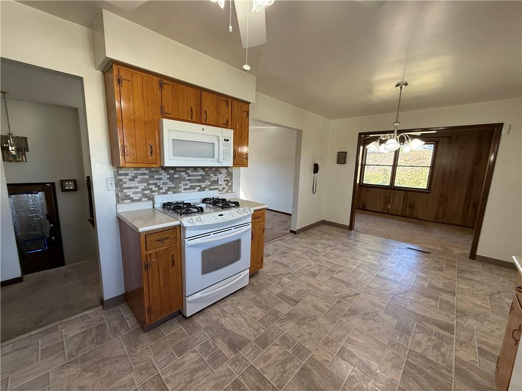 18 Water Street Smithfield, PA 15478 - Photo 7 of 26 a kitchen with stainless steel appliances granite countertop a stove a sink and a refrigerator