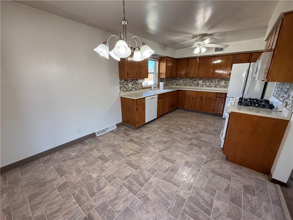 18 Water Street Smithfield, PA 15478 - Photo 9 of 26 a kitchen with stainless steel appliances granite countertop a sink a counter space cabinets and a chandelier