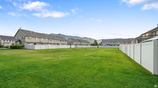 983 South 1850th Street West Springville, UT 84663 - Photo 21 of 30 Expansive green space featuring a vinyl privacy fence and mountain backdrop
