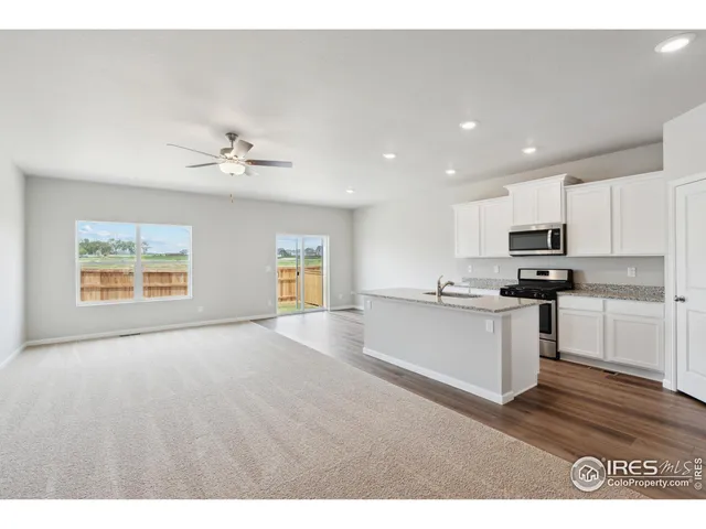 a view of kitchen with sink microwave and cabinets