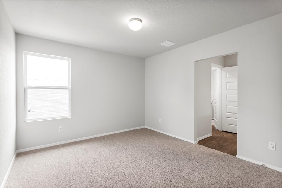 13300 Riding Drive Manor, TX 78653 - Photo 27 of 38 Spare room with dark colored carpet and baseboards