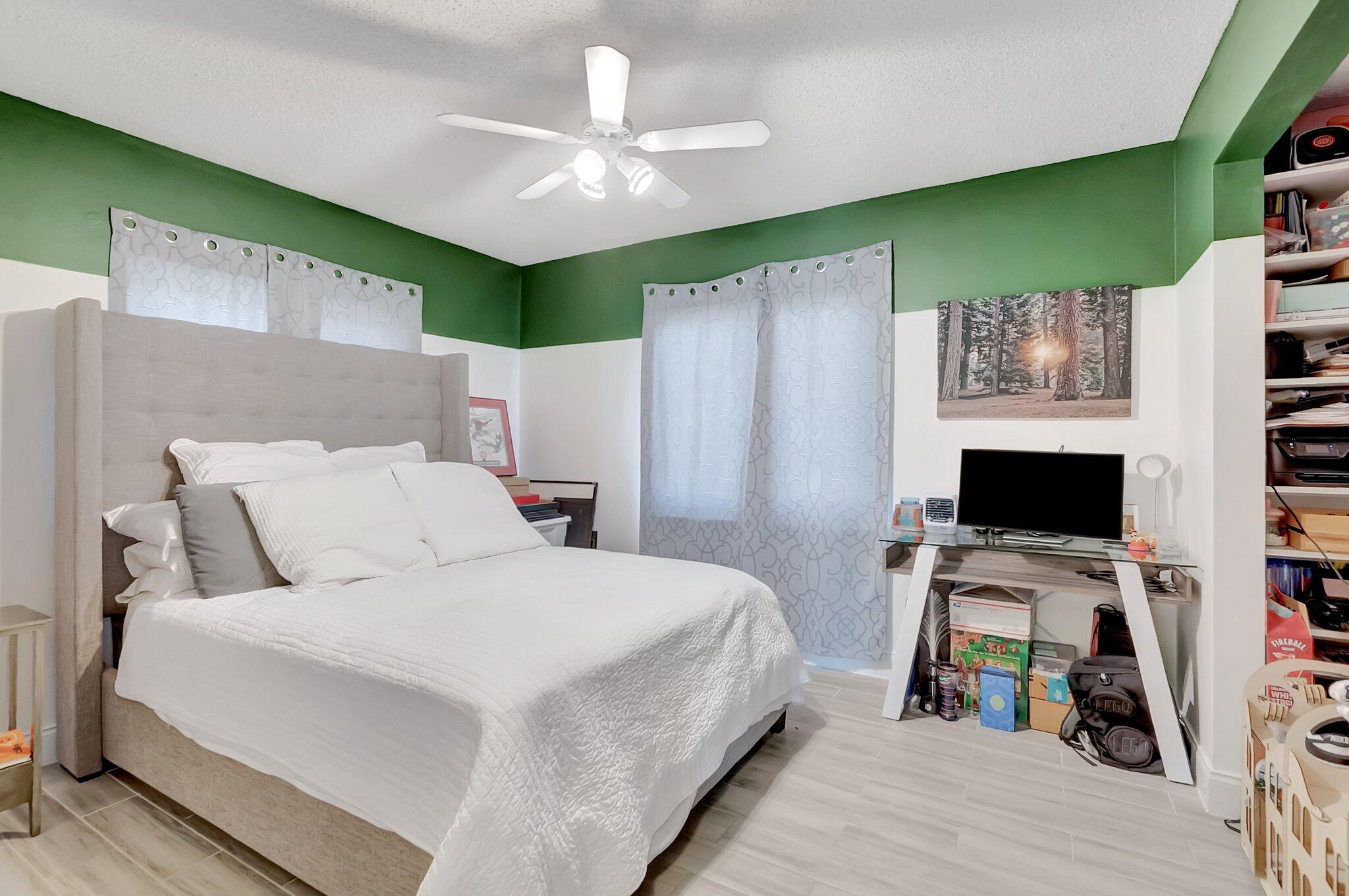 22505 Labrador Street Boca Raton, FL 33428 - Photo 27 of 35 a bed room with a bed tv and a fish tank