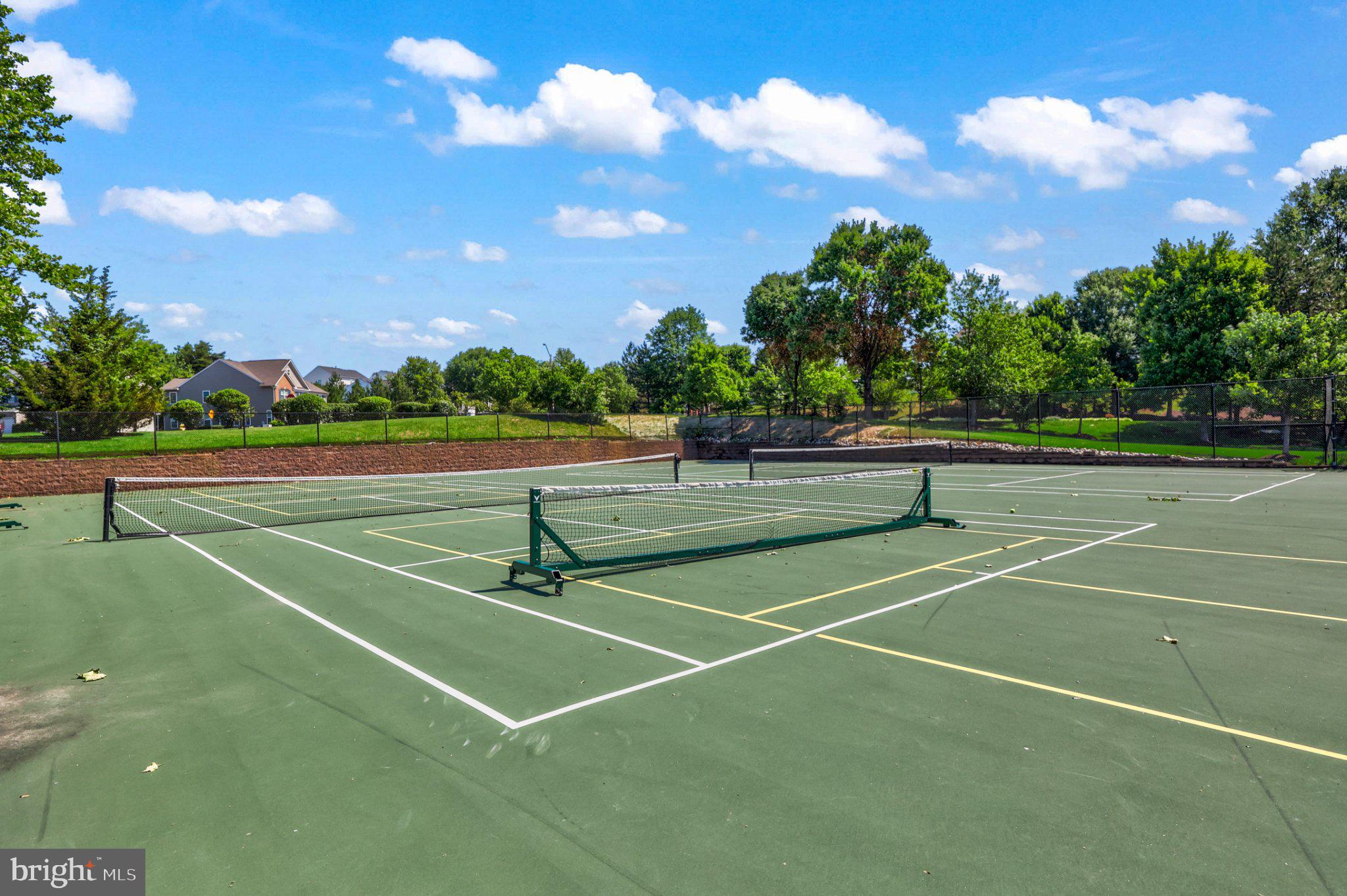 16183 Raptor Crest Lane Woodbridge, VA 22193 - Photo 49 of 51 Sunny tennis court in lush surroundings.