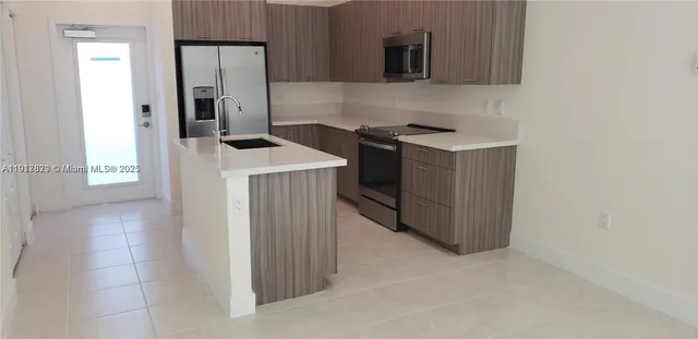 a kitchen with a stove and a refrigerator