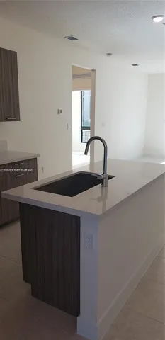 a close view of a sink a counter space and a window