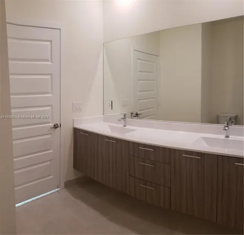 a bathroom with a double vanity sink and a mirror