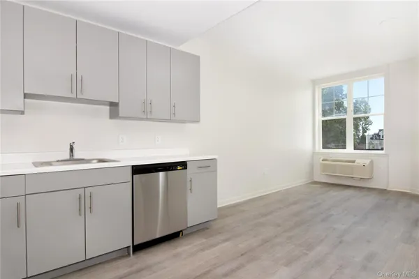a kitchen with a sink cabinets and a window