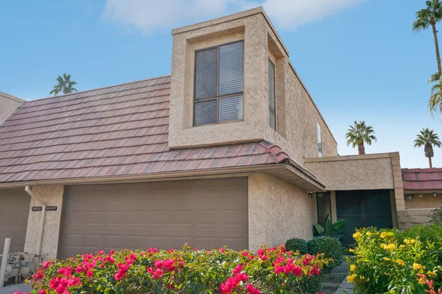 a front view of a house with garage