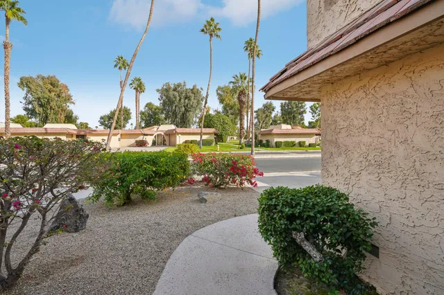a view of a house with a yard and sitting area