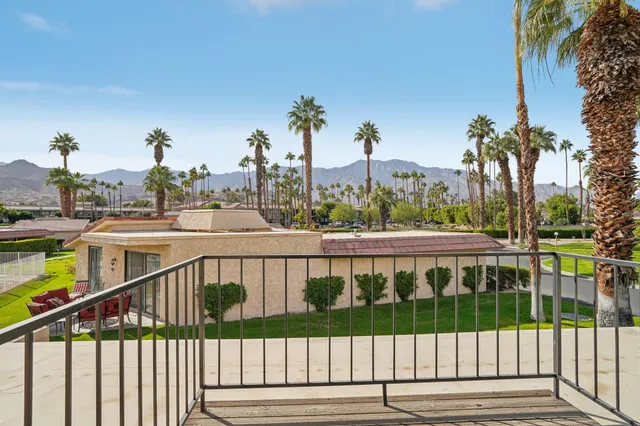 a grassy field with trees in the background
