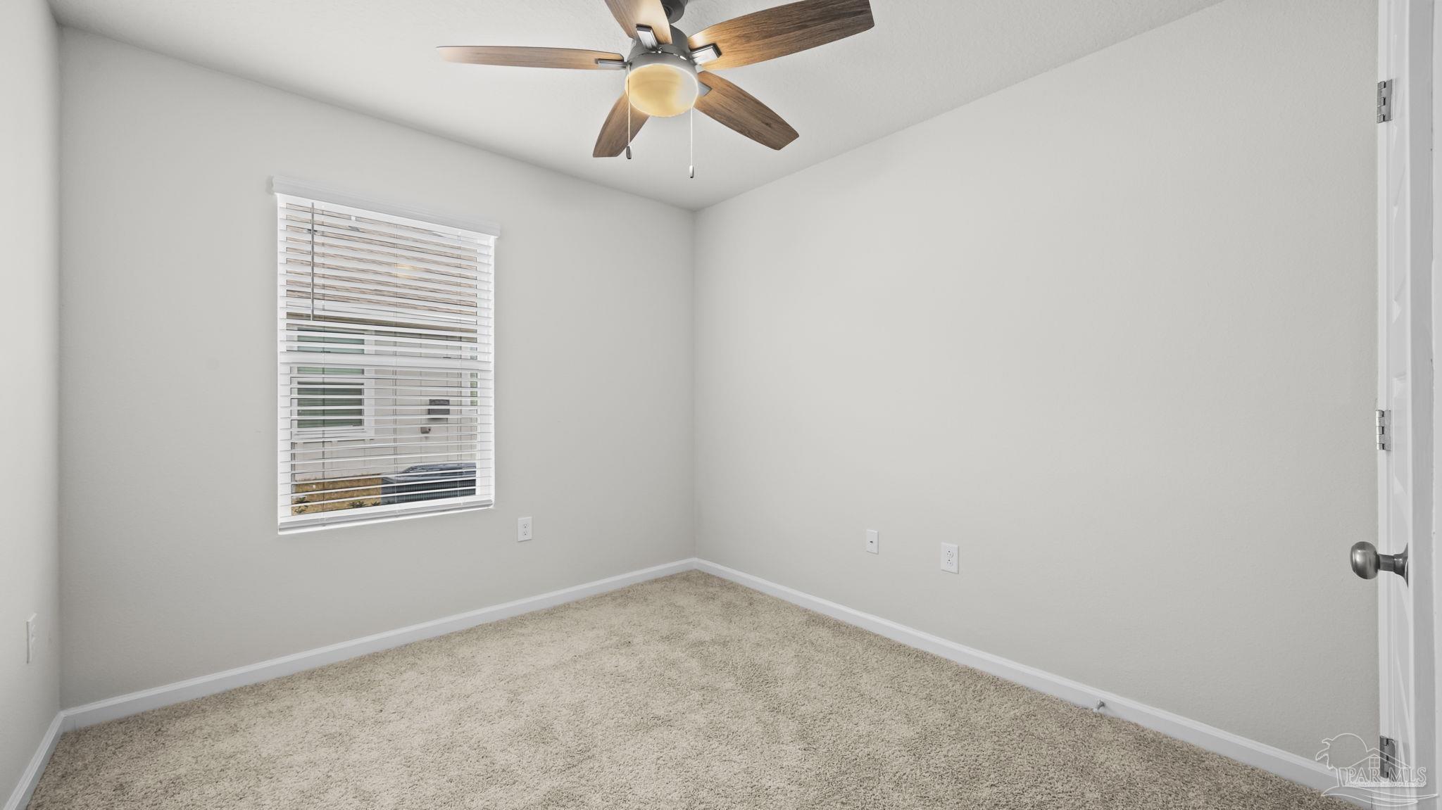 22483 Aleutian Avenue Foley, AL 36535 - Photo 14 of 27 an empty room with a window and a fan