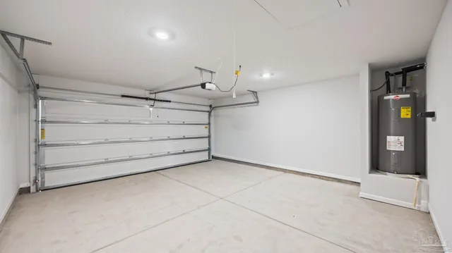 a view of an empty room with cabinet and stairs