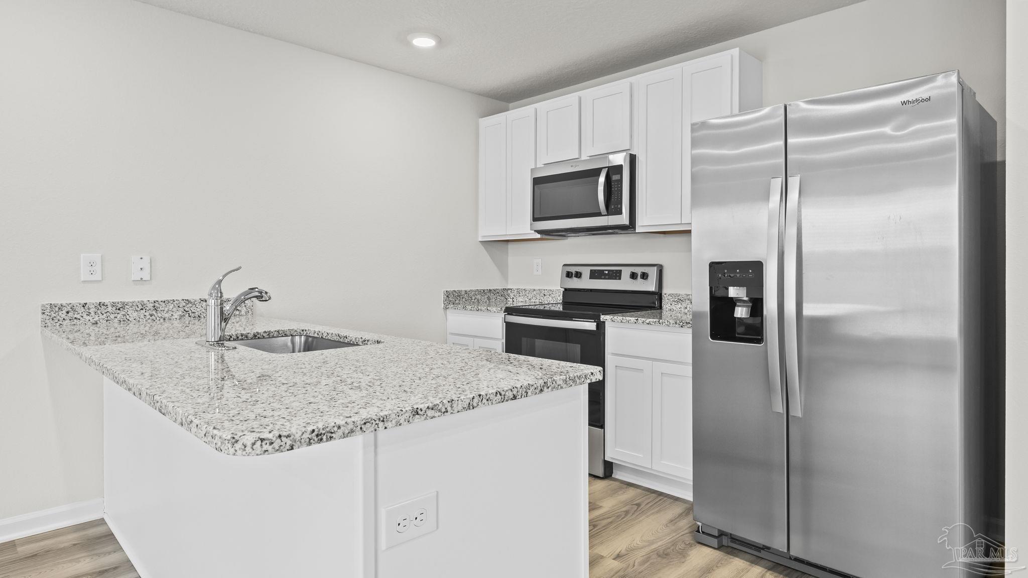 22483 Aleutian Avenue Foley, AL 36535 - Photo 8 of 27 a kitchen with stainless steel appliances granite countertop a refrigerator a stove and a sink