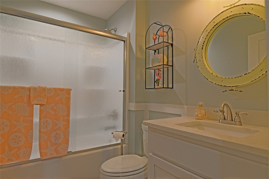 1102 White Street Fernandina Beach, FL 32034 - Photo 16 of 32 a bathroom with a granite countertop toilet sink and shower