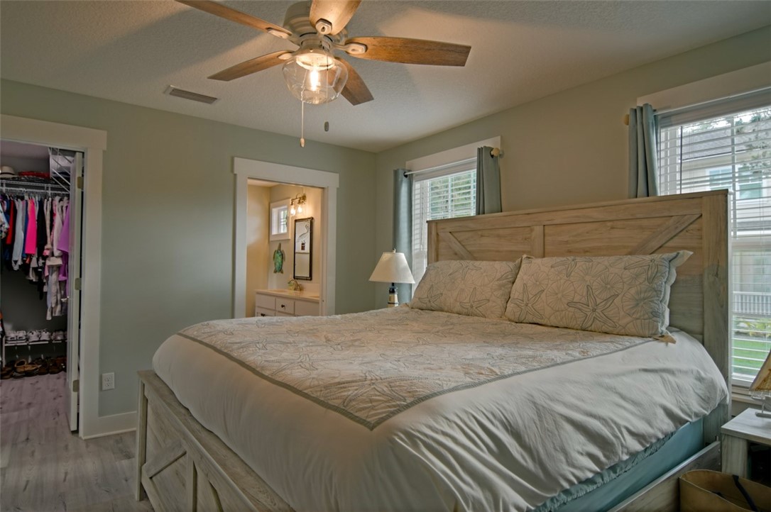 1102 White Street Fernandina Beach, FL 32034 - Photo 10 of 32 a bedroom with a large bed and a chandelier