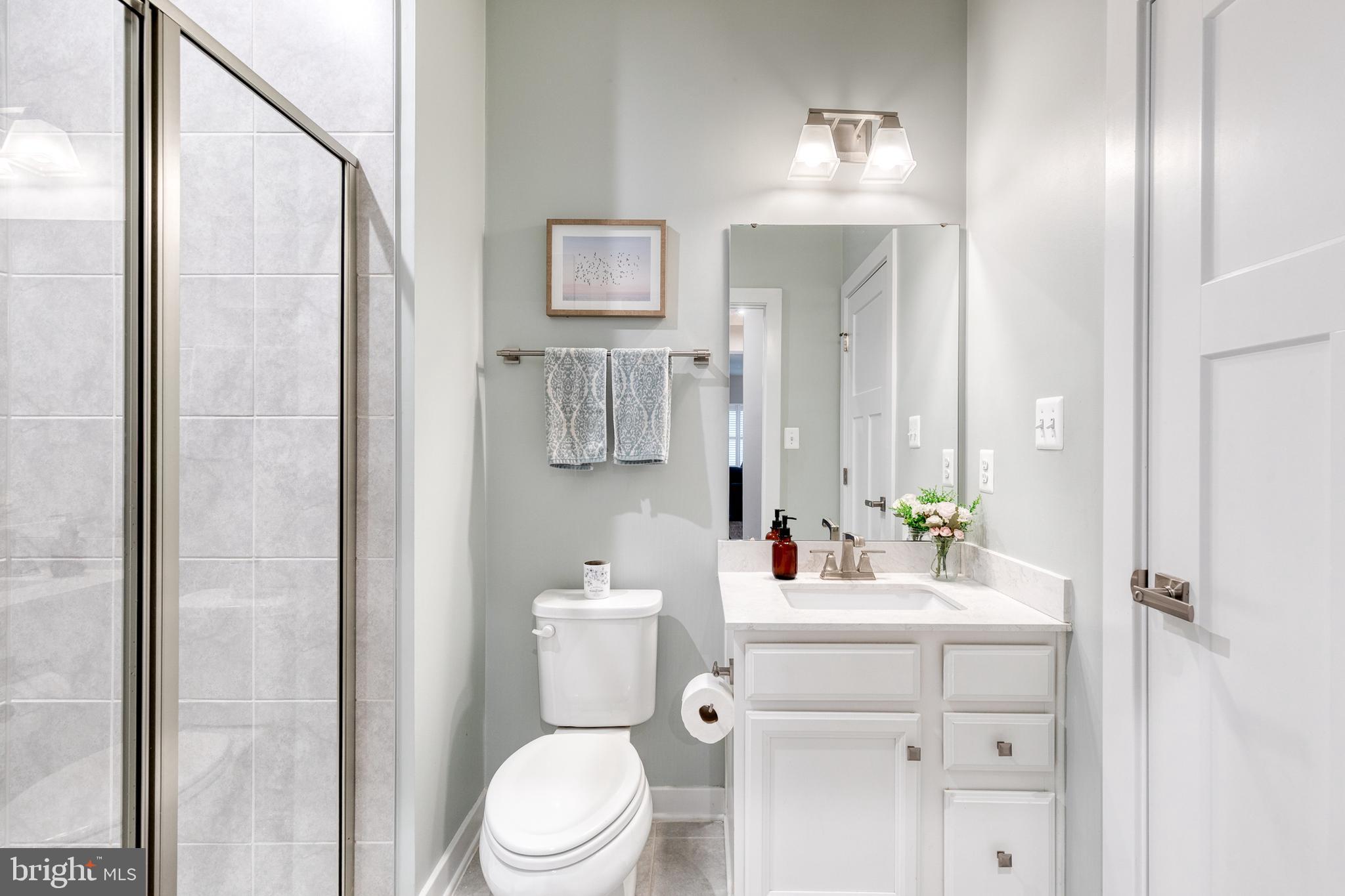 6003 Valentine Way Hanover, MD 21076 - Photo 27 of 52 a bathroom with a sink vanity mirror and toilet